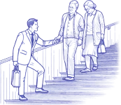 An insurance agent helping an elderly couple down a flight of stairs