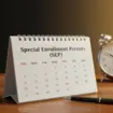 Calendar titled 'Special Enrollment Periods' with a clock on a desk.